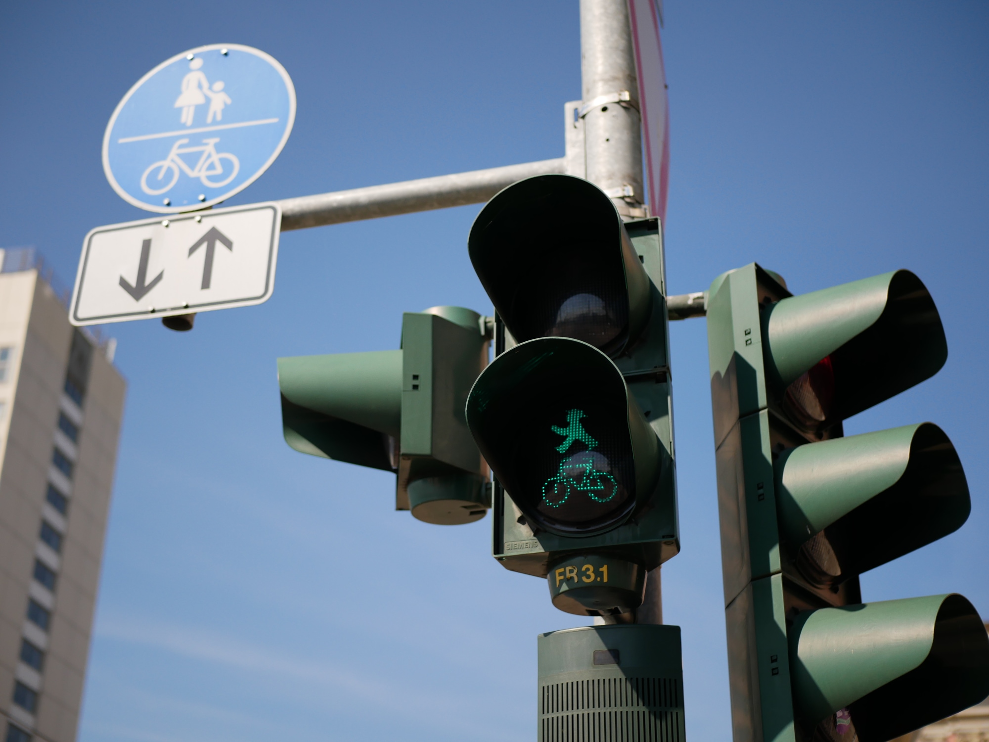 A photo taken of an Ampelmännchen plus Fahrrad pedestrian signal in Potsdam.
